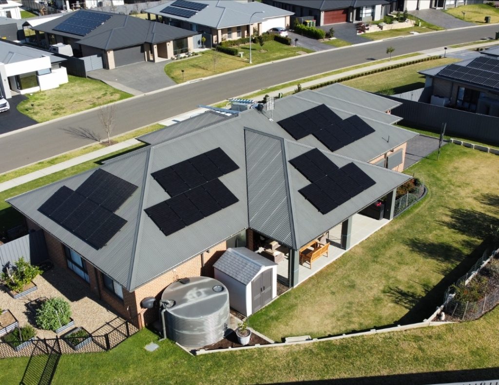 bird's-eye view of a residential area showcasing solar panels on several houses